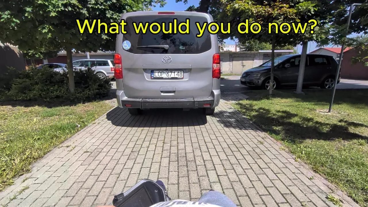 A real car blocking a pavement, shown in the Witek Adventures trailer.